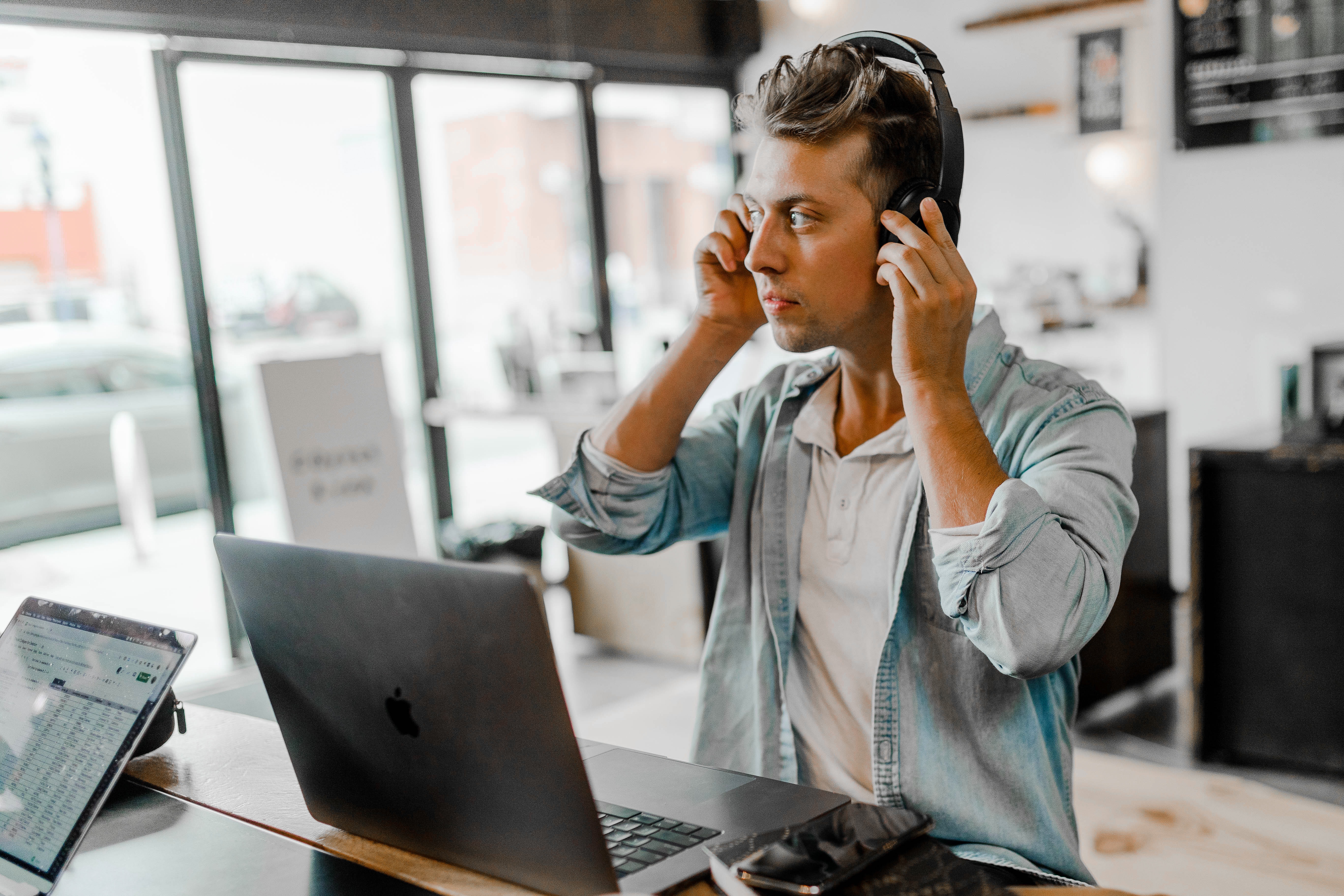 Young man at laptop with headphones on