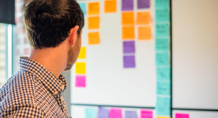 Man looking at SCRUM board