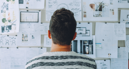 Man looking at wall of design and prototype elements