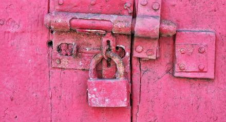 Red padlock on a red door